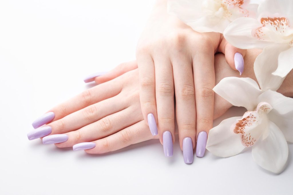 girl-s-hands-with-delicate-purple-manicure-orchid-flowers (1)